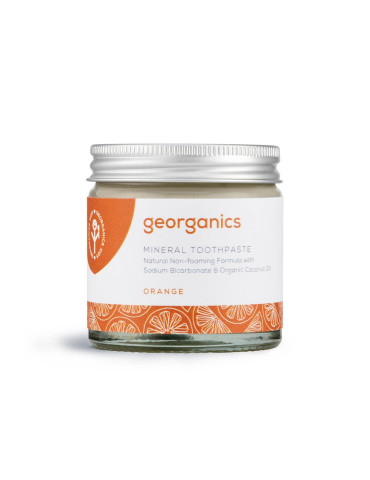 Orange-flavored toothpaste in a glass jar